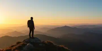 Determined person on mountain peak at sunrise, symbolizing self-discipline and personal growth